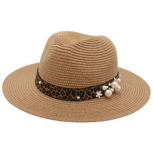 Detail of Panama straw hat with leopard print ribbon and white pearl floral accents