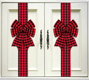 Detail of red and black buffalo plaid ribbon bows installed on white kitchen cabinet doors