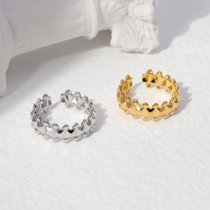 Detail of geometric stainless steel open rings with metallic beads in gold and silver