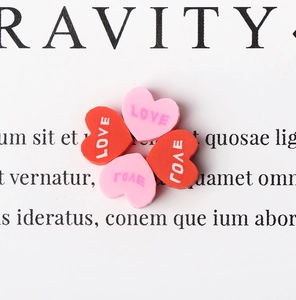 Close-up of heart-shaped polymer clay beads with LOVE lettering for DIY jewelry making