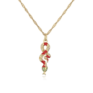 Macro shot of 18K gold plated snake pendant with red green enamel and clear zircons