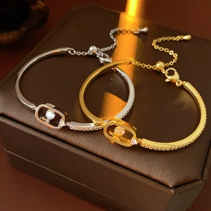 Macro shot of 18k gold and silver plated chain bracelets with sparkling zircon stones