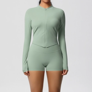 Front view of women's yoga set featuring zip-up long sleeve top and high-waisted shorts