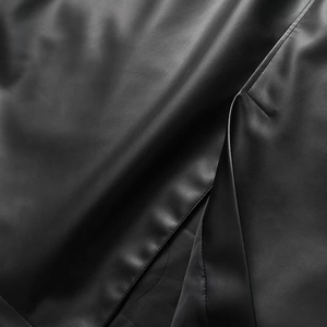 Close-up of black leather texture with detailed stitching for a long trench coat