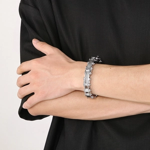 Detail of silver stainless steel cable chain bracelet on male model wrist
