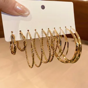 6-pair set of gold hoop earrings featuring twisted textures and smooth minimalist designs