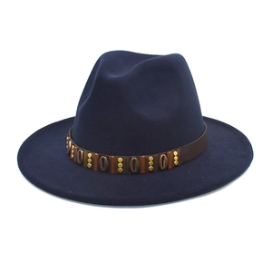Detailed view of navy wool fedora hat with ethnic leather band and shell accents