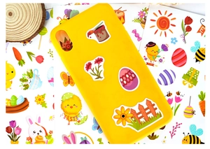 Easter stickers with bunnies and eggs applied on a yellow phone case for spring decor