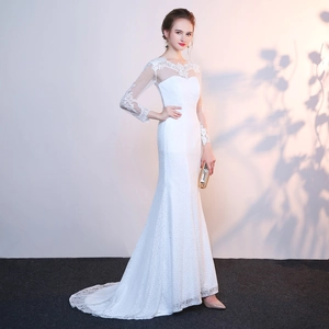 Elegant long sleeve lace mermaid wedding dress with sheer mesh and a graceful train