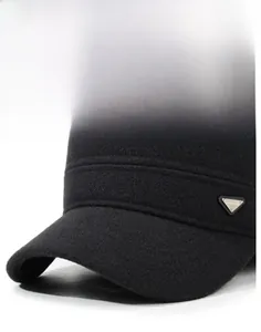 Detailed macro of stiff black wool brim with triangular metallic FASHION emblem