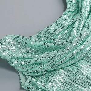 Detail of mint green sequin fabric with pleated texture on a sleeveless slit evening dress