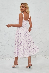 Detailed back view of a white floral sun dress with elegant side slit and thin straps