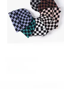 Detail showing six colors of checkered knit beanies including blue, green, and pink