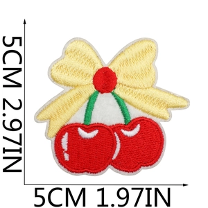 Detail showing cherry and bow embroidered patch with 5cm dimensions on white background