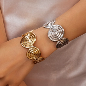 Minimalist wide spiral cuff bracelet with textured metallic finish in gold and silver