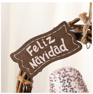Detail of wooden Christmas wreath with shiny sequins and white Feliz Navidad inscription