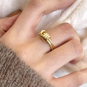 Minimalist gold knot ring for women featuring a classic intertwined metal rope design