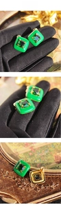 Detail of vintage square emerald green stud earrings with gold metal frame