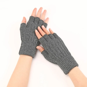 Detail of grey knitted fingerless gloves with ribbed cuffs showing wool texture