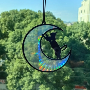 Rainbow suncatcher featuring a black cat on a crescent moon for window decoration