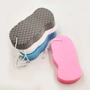 Close-up of 3D bath sponges with fish scale texture and hanging ropes in four colors
