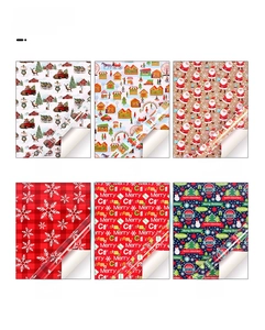 Detail view of six Christmas wrapping paper rolls featuring snowflakes, houses and trees