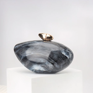 Chic marble pattern acrylic clutch bag with a golden teardrop clasp for evening events