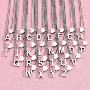 Titanium steel necklaces with A-Z letter pendants and hearts on pink background