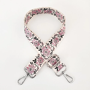 Detail of adjustable floral strap with pink flowers and silver metal hooks
