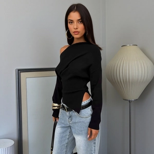 Slim fit black one-shoulder long sleeve top paired with light blue washed denim jeans
