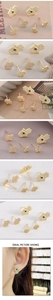 Detailed views of gold Hamsa earrings with white zircon and blue crystal accents on models