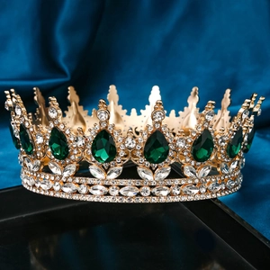 Detailed close-up of a luxury gold bridal tiara featuring teardrop green gemstones