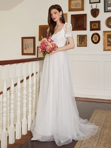 Elegant white lace wedding dress with a V-neck, floral lace sleeves and layered mesh skirt