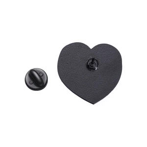 Macro detail of heart-shaped brooch back with matte black finish and rubber clutch