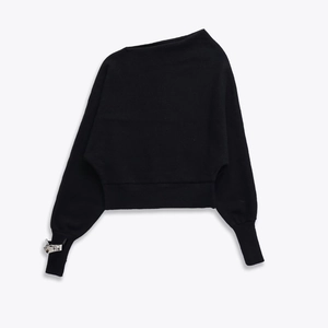 Black asymmetric off-shoulder knit top with silver geometric metal detail on cuffs