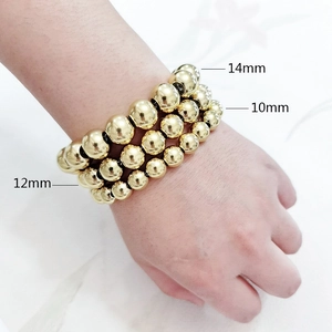 Detailed comparison of 10mm, 12mm and 14mm polished gold stainless steel beads on wrist