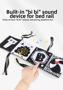 Detail of high-contrast baby cloth book featuring built-in squeaker for sensory play