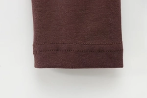 Detailed view of the double-needle stitching on the dark brown modal long sleeve t-shirt