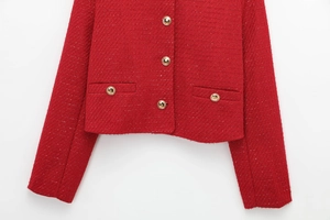 Close-up of red tweed jacket featuring golden buttons and symmetrical front pockets