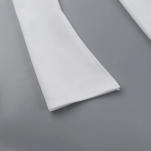 Close-up of precise double-stitching on white woven trousers leg hem detail