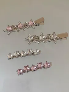 Macro detail of silver star hair clips with sparkling pink and clear rhinestones