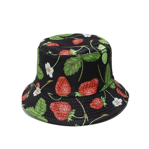 Detail of strawberry pattern print on black summer bucket hat with white flowers