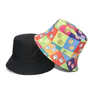 Reversible bucket hat with cute dog paw prints in black and vibrant patchwork colors