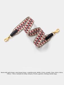 Macro detail of 3.8cm woven shoulder strap with ethnic pattern and gold metal buckles