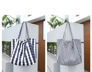 Detail view of tote bags featuring large and small blue and white checkered patterns