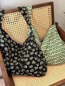 Floral cotton tote bags with vintage heart and tulip patterns shown on a wooden chair
