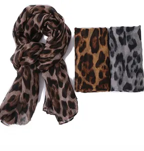 Detailed view of lightweight leopard print scarves in brown and grey color options