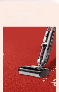 Detailed view of red Belgian velvet rug being cleaned easily with a handheld vacuum