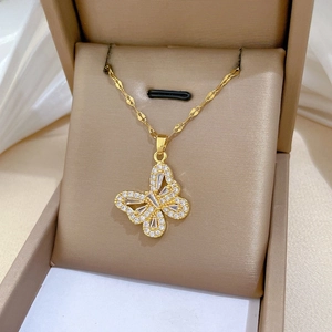 Macro shot of a gold butterfly pendant necklace with sparkling pavé cubic zirconia