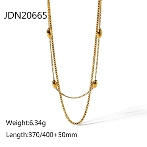 Detailed view of vintage gold layered necklace with oval beads and product dimensions